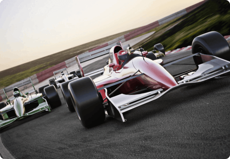 A race car driving down the track in front of some other cars.