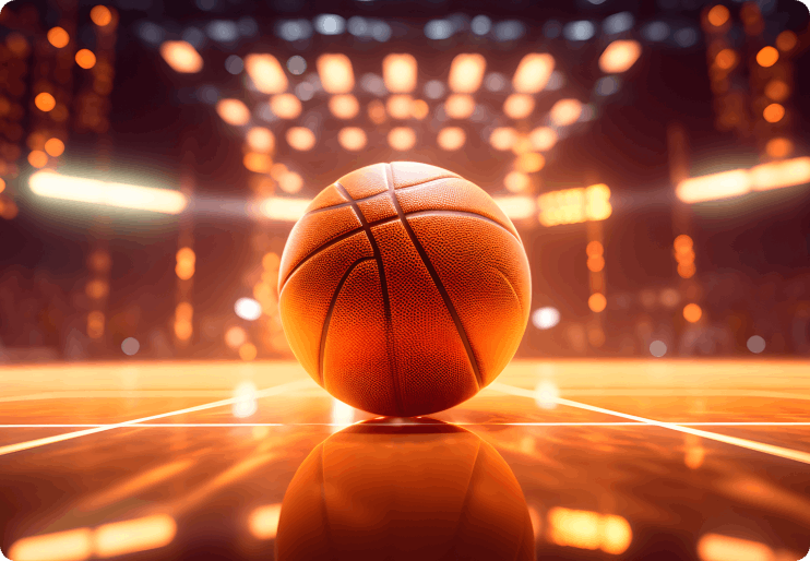 A basketball is on the court with lights in the background.