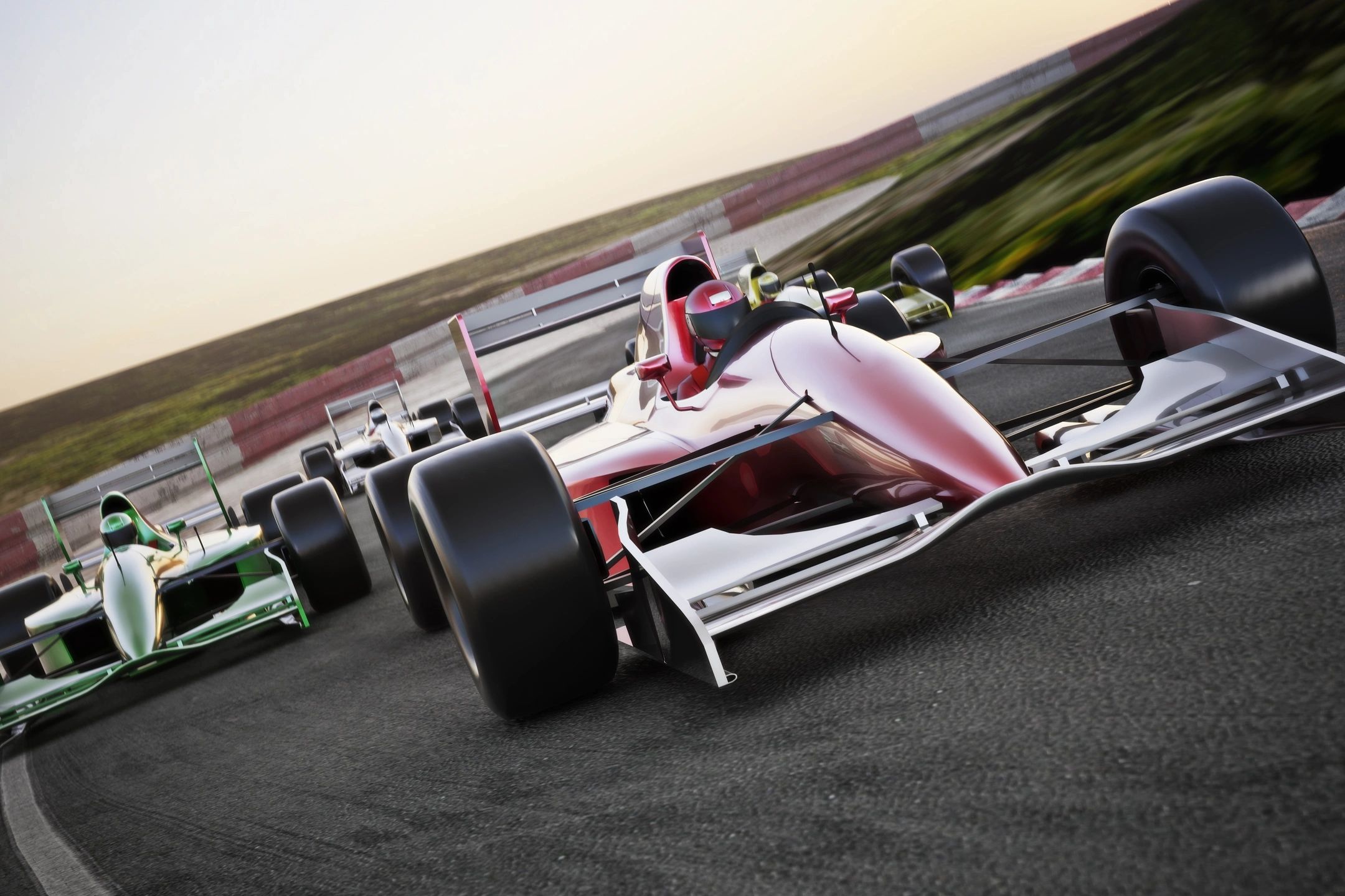 A race car driving down the track with other cars behind it.