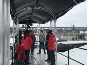 A group of people standing under an awning.